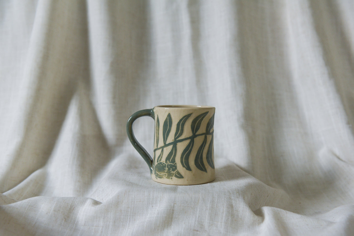 Cat among Leaves Mug